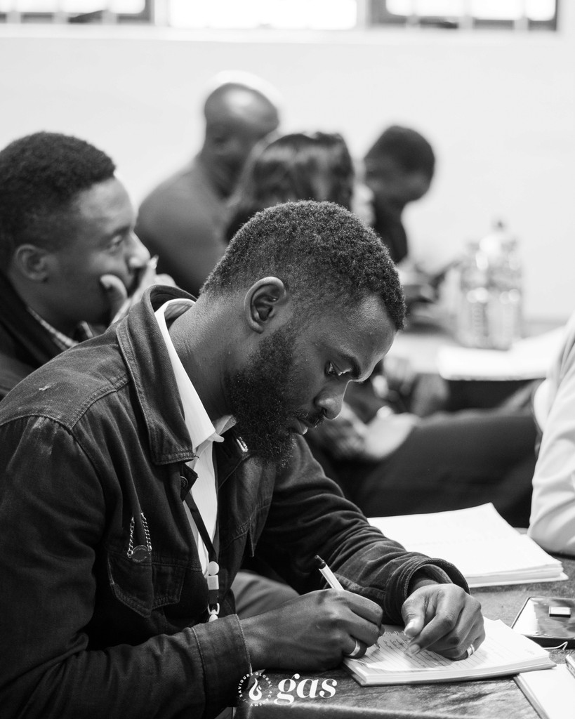 Church leaders taking notes during a session